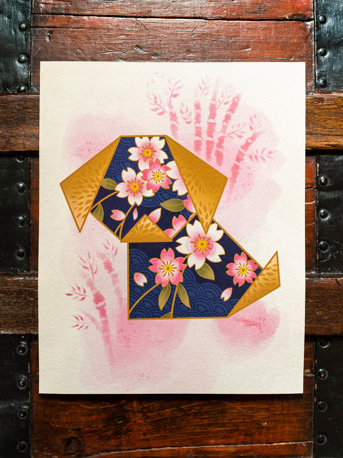 Origami Dog blue and gold art print made by tattoo artist Megan Massacre on a wooden  background