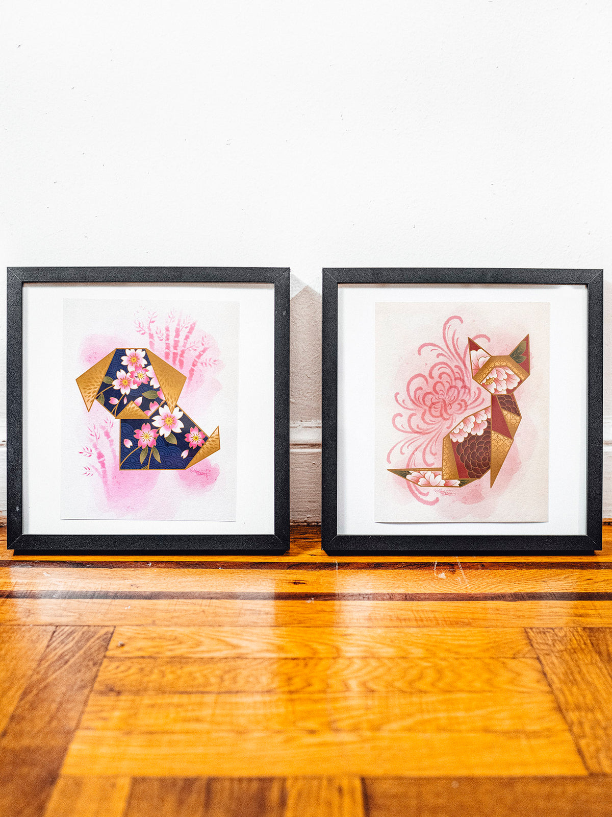 Framed versions of the origami dog and cat prints designed by Megan Massacre