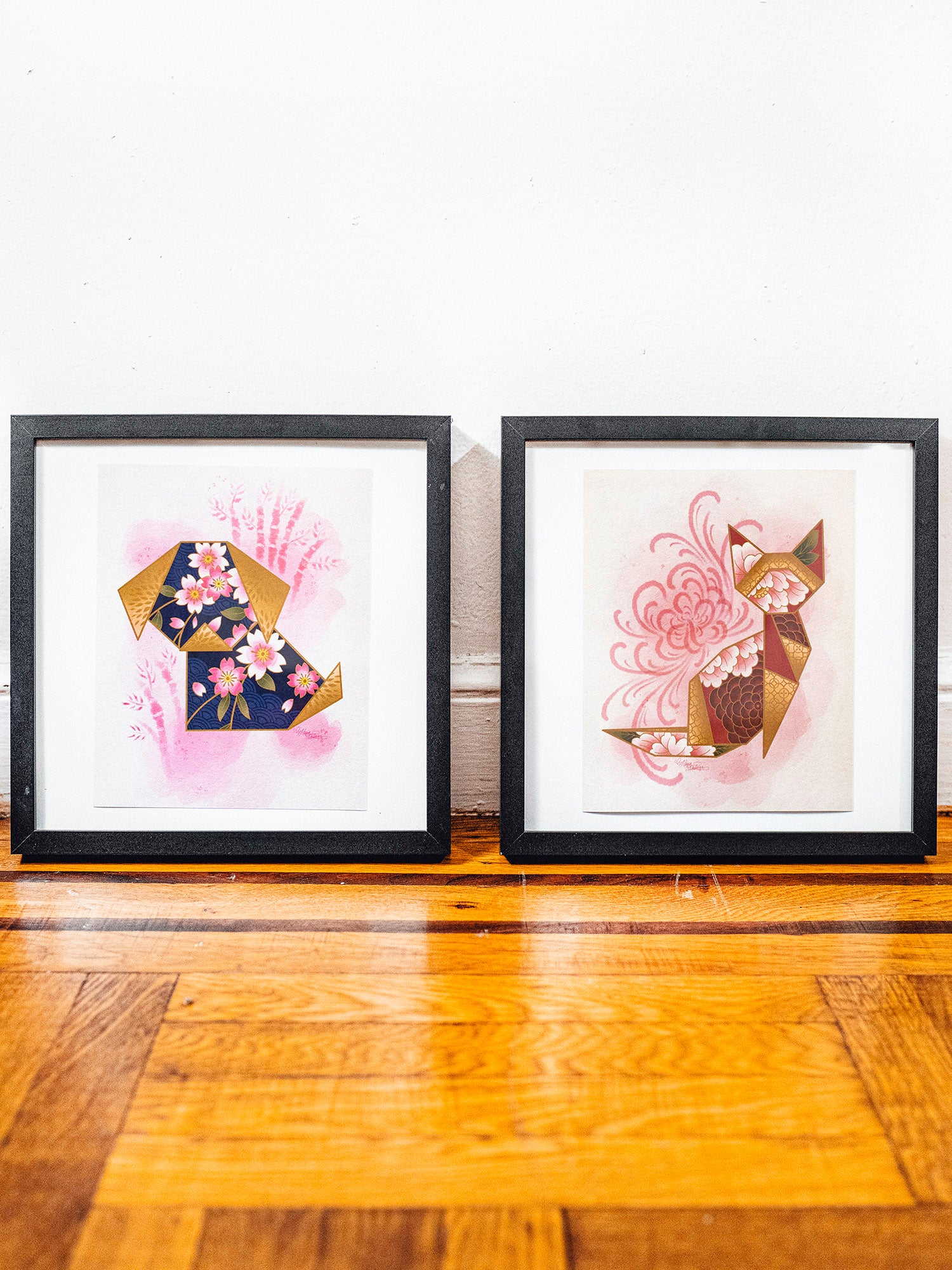 Framed versions of the origami dog and cat prints designed by Megan Massacre