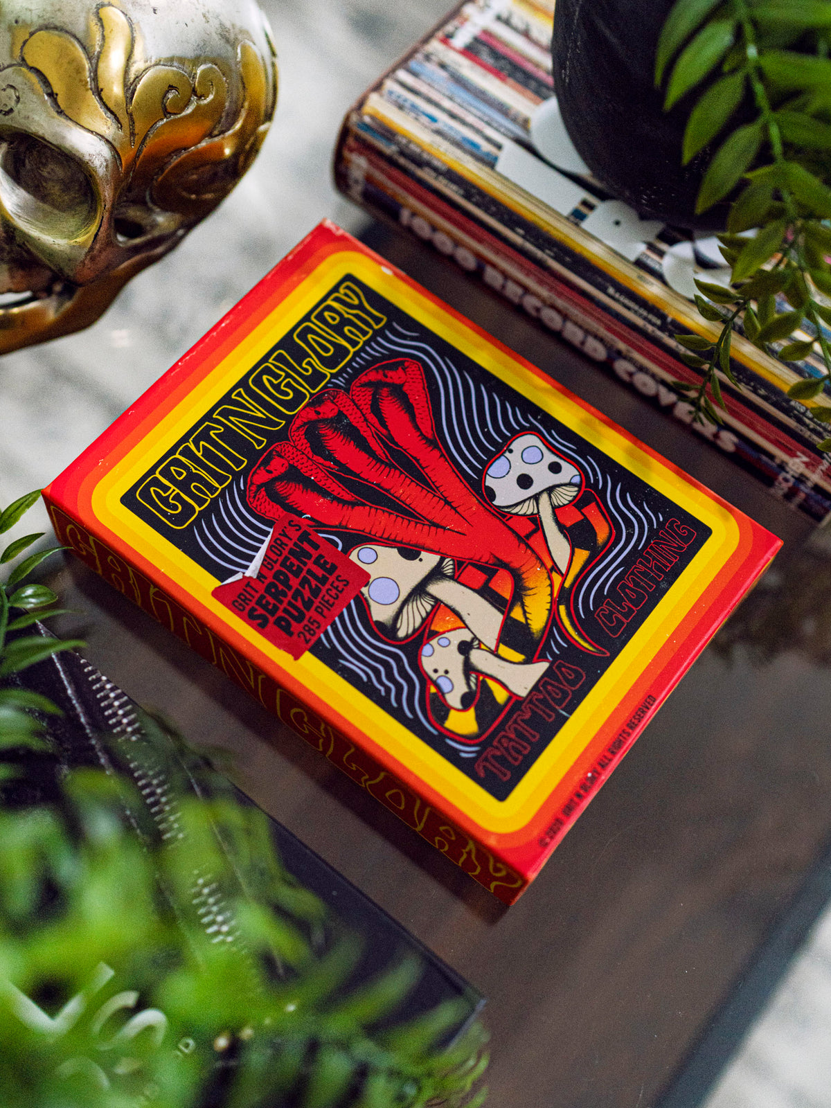 A puzzle box with a yellow and black multi headed cobra design, featuring the text 'Serpent Puzzle' and 'Grit N Glory'.