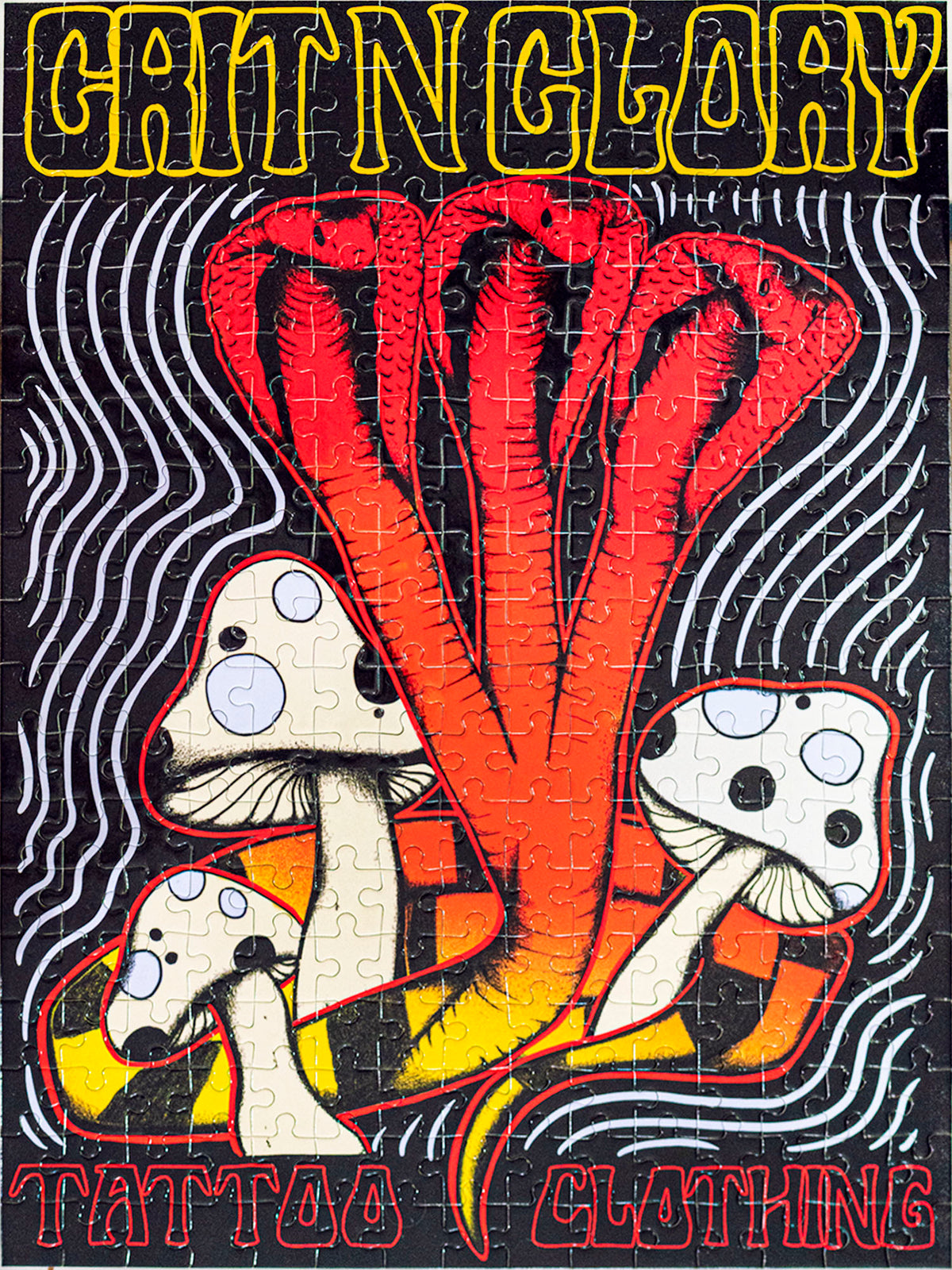 A puzzle with a yellow and black multi headed cobra design, featuring the text  'Grit N Glory'.