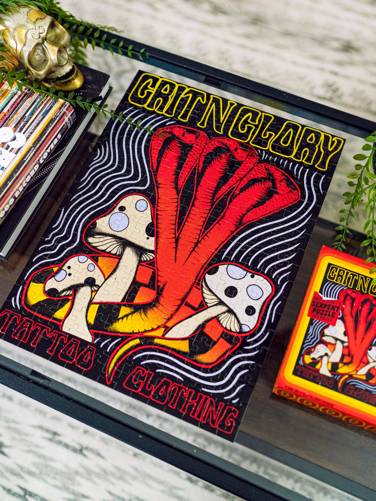 A puzzle with a yellow, purple, and black multi headed cobra and mushroom design, featuring the text "Grit N Gory"