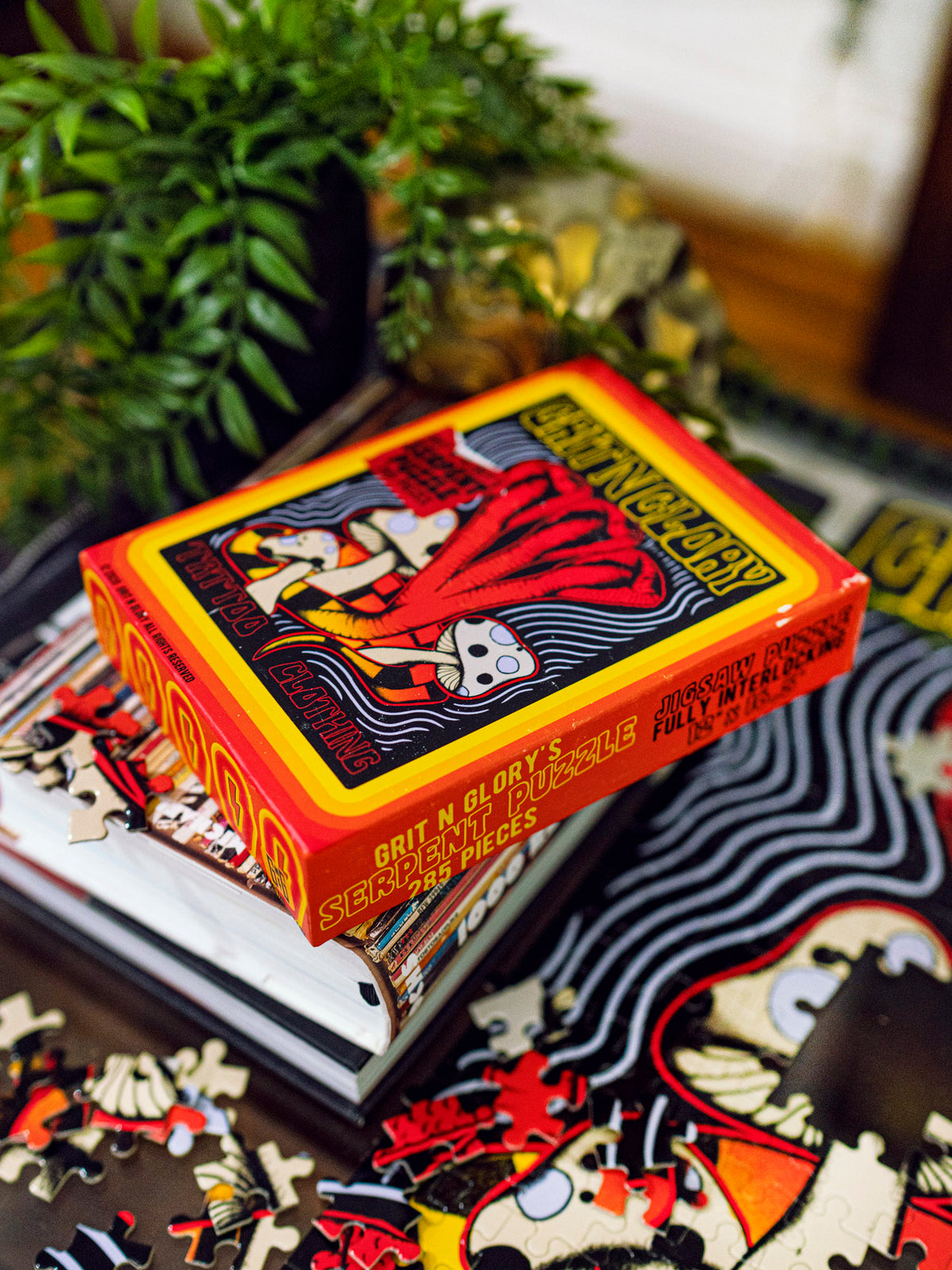 A puzzle box with a yellow and black multi headed cobra design, featuring the text 'Serpent Puzzle' and 'Grit N Glory'.