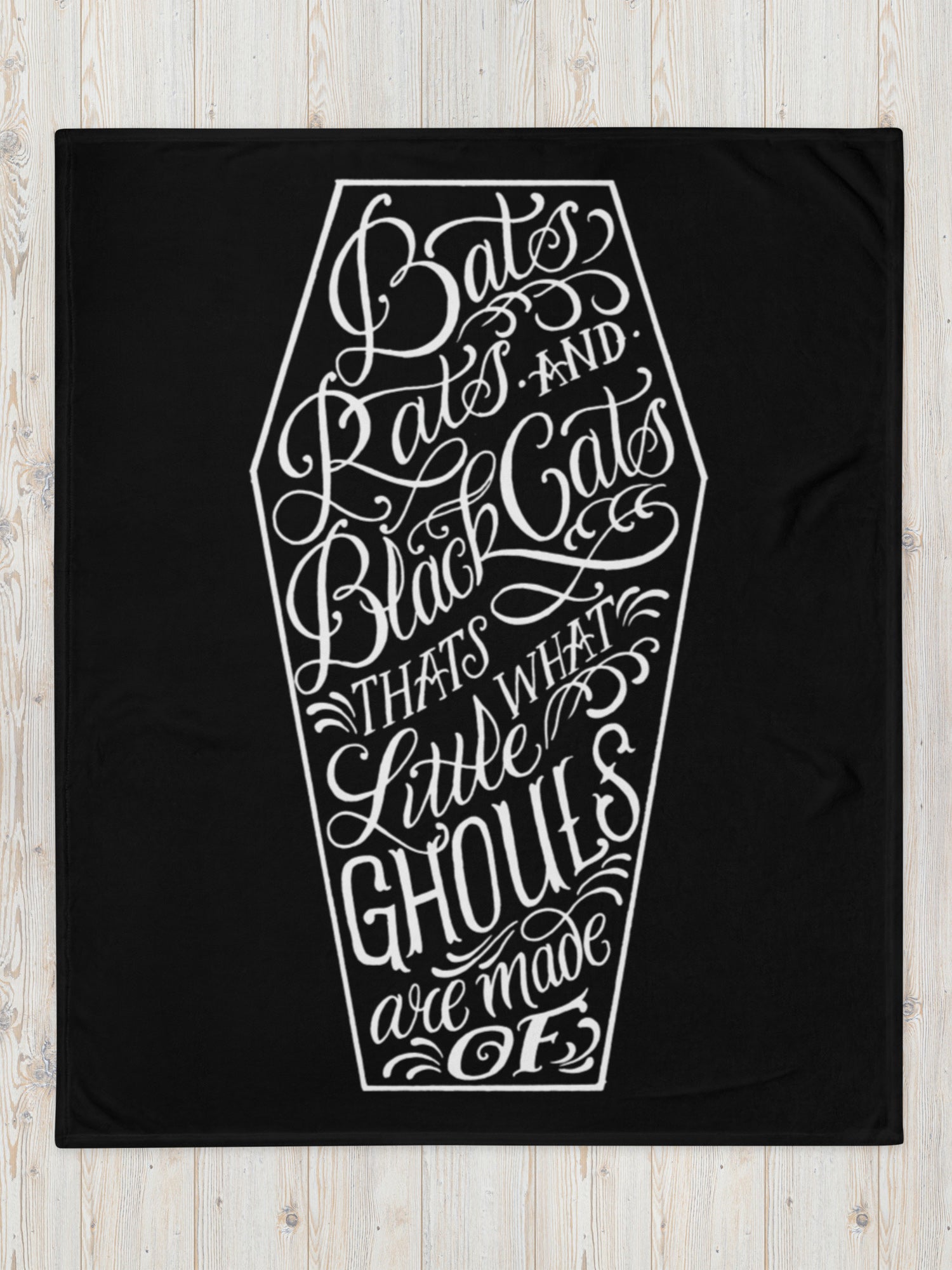 A black blanket with white text and graphic coffin design that reads 'Bats, Rats, and Black Cats - That's What Little Ghouls are Made of'.